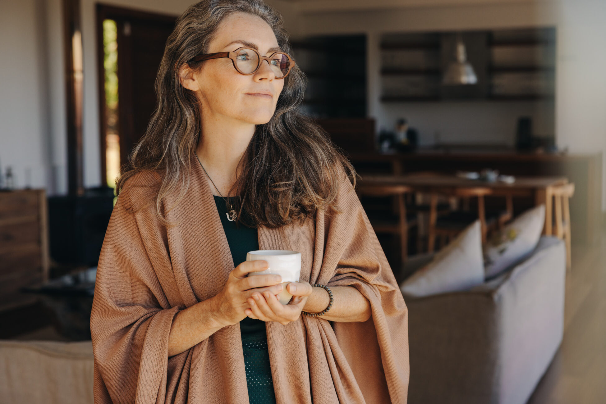 Middle aged woman enjoying morning coffee at home